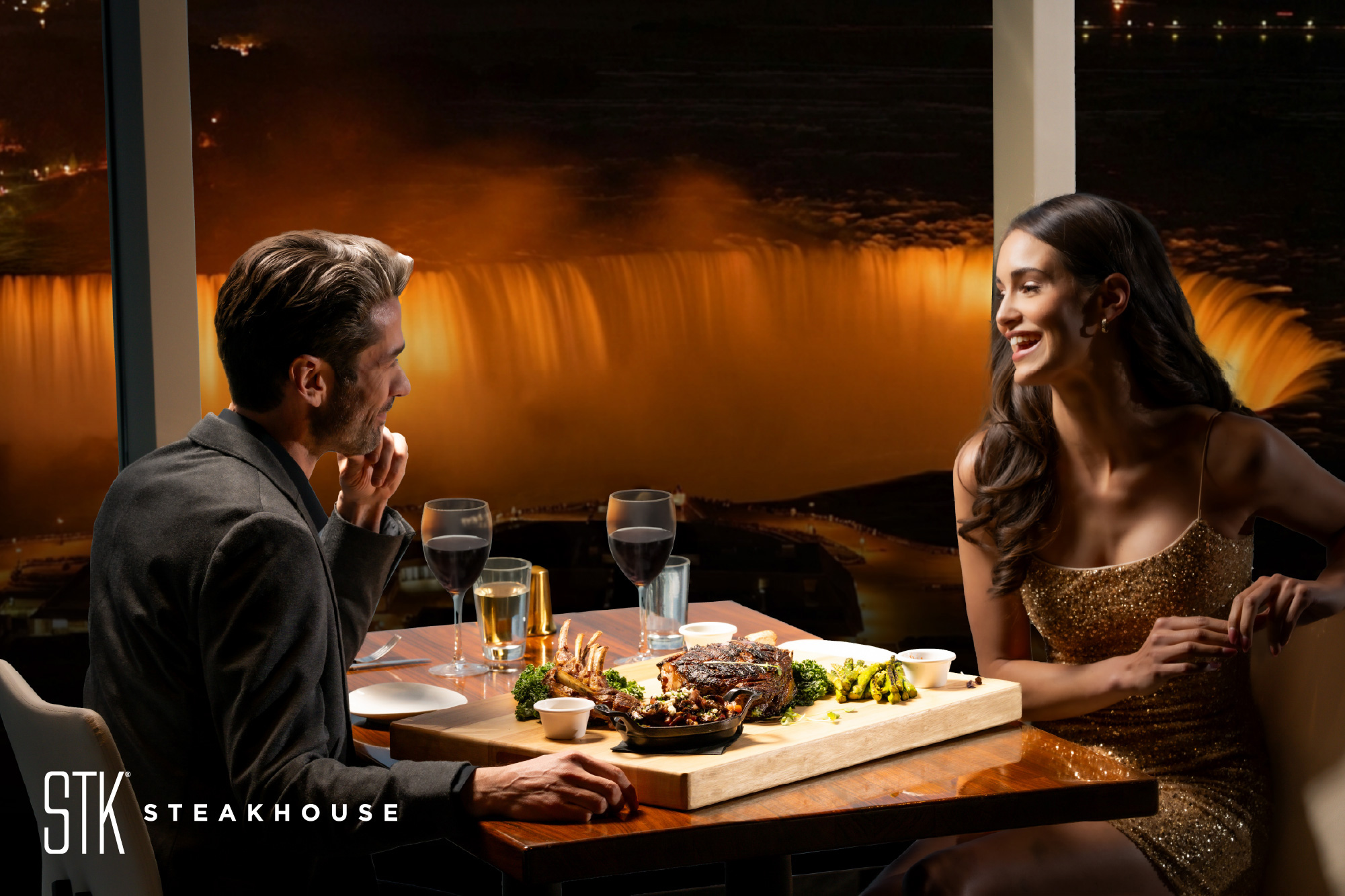 Guests enjoying dinner at STK Steakhouse with views of Niagara Falls.