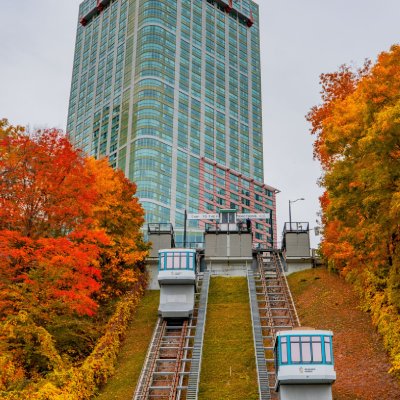 Incline railway system going uphill to hotel surrounded by Autumn foliage
